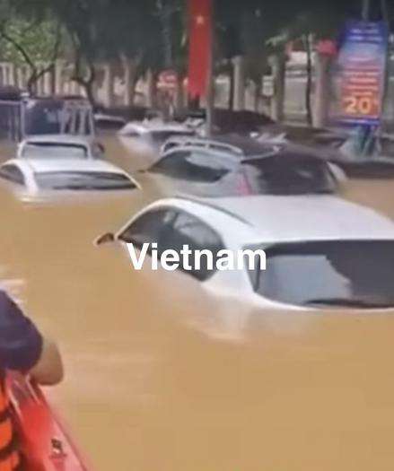 Straße in Viernam. Autos unter Wasser.