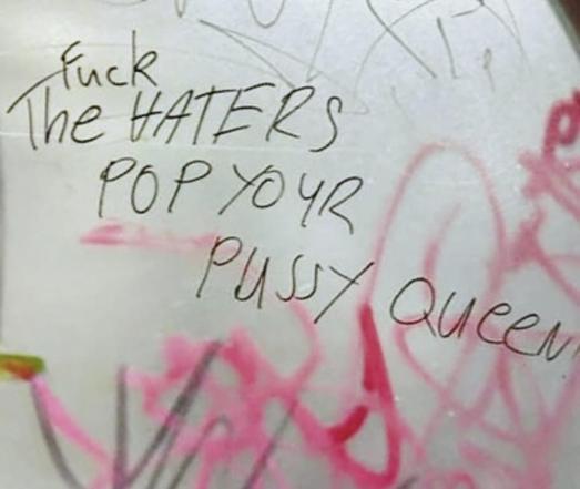 bathroom graffiti that says “fuck the haters. pop your pussy queen”