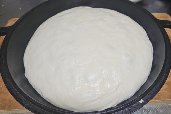 a photo of a relaxed dough sitting in a pan