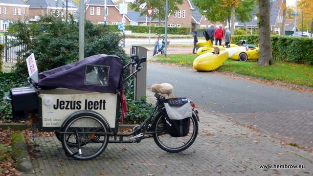 A cargo trike / bakfiets parked near the meeting point for our Sunday ride. It's got "Jezus leeft" written on the side, which of course means "Jesus lives". You could also read it as "Your sister lives" if you mentally insert a space between the e and z. Anyway, I've quite often seen this trike pootling around in the area. Its owner puts up religious posters.

There's also another guy with a similar setup who rides another bakfiets around Assen who does the same thing

Perhaps those two are just the tip of the iceberg and there are actually hundreds of them riding a well organised fleet of bakfietsen around the country trying to convert us all...