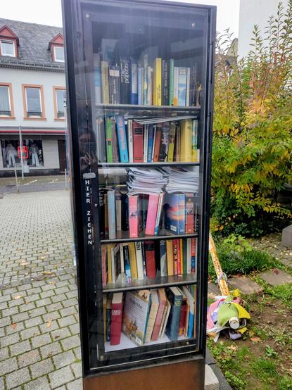 The other side of the free library, also filled with many books.