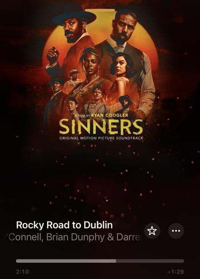 The image features a movie poster for "Sinners," directed by Ryan Coogler, showcasing various characters against a dramatic backdrop. At the bottom, the title "Rocky Road to Dublin" appears along with artist credits. The overall aesthetic is dark