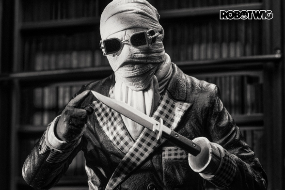 The invisible man wrapped in bandages stands in front of a bookcase with one finger touching the end of a sharp knife he's holding in his invisible hand.