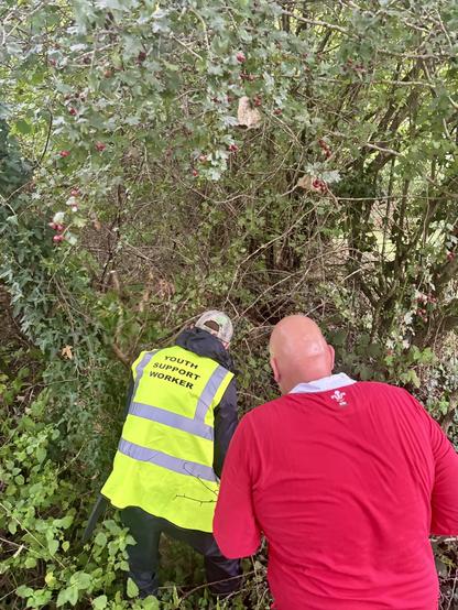 Two volunteers working together to clear the blocked right of way