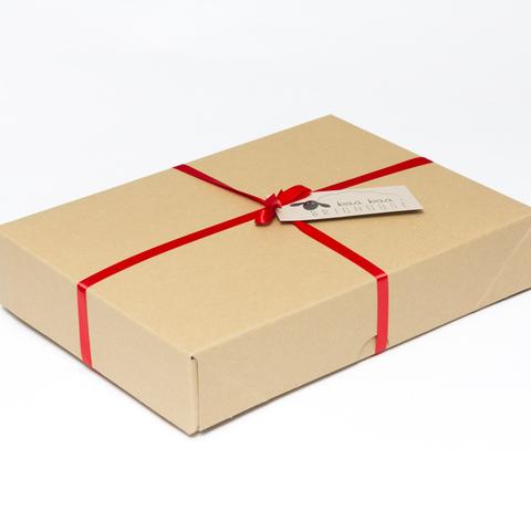 Picture shows a closed A4 box tied with red tibbon.