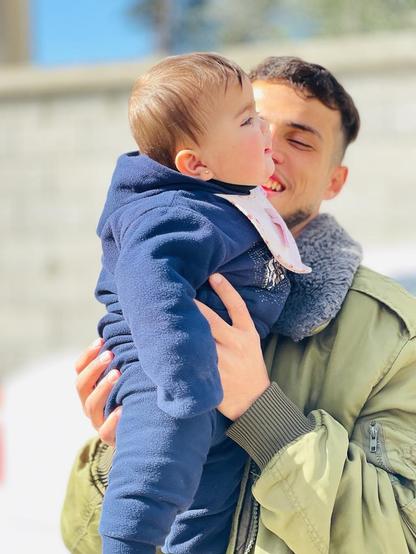 Khaled Zeyada, 21 years old, from Rafah, Gaza, holding my baby niece in my arms.