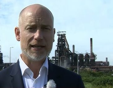 Stephen Kinnock MP standing in front of Port Talbot's Tata Steelworks (Image: BBC)