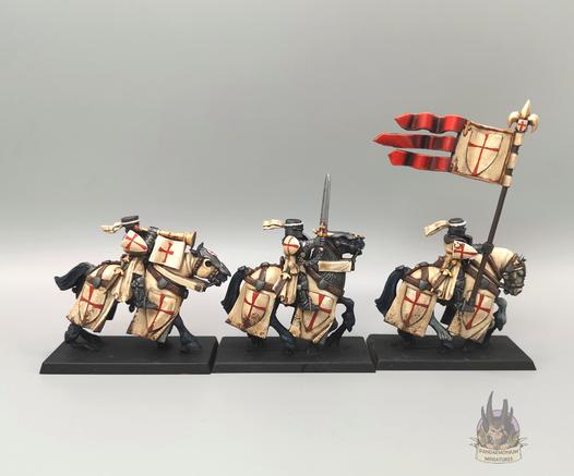 The command group of musician with bugle, champion with sword, and standard bearer in profile, right side