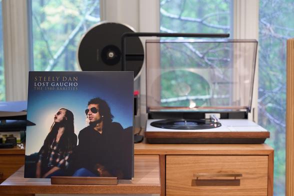 Steely Dan - Lost Gaucho, the 1980 Rarities LP cover.

A backlit shot of Becker and Fagen, back in the day. Just off camera, most likely, a lot of coke.

The black LP plays on a vintage, restored Bang & Olufsen Beogram 4000 linear-tracking turntable to the right.