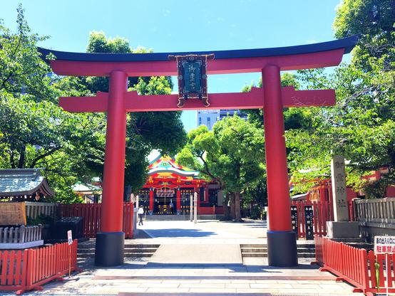 A big bright red wooden torii gate in the foreground and some 50m or 150ft back the actual shrine.