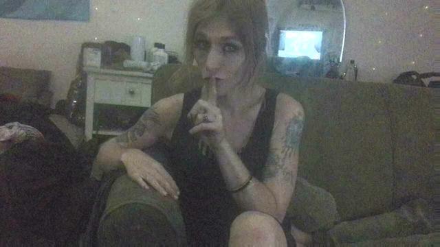 Attractive redheaded girl holding a finger to her mouth telling the viewer to shhhh