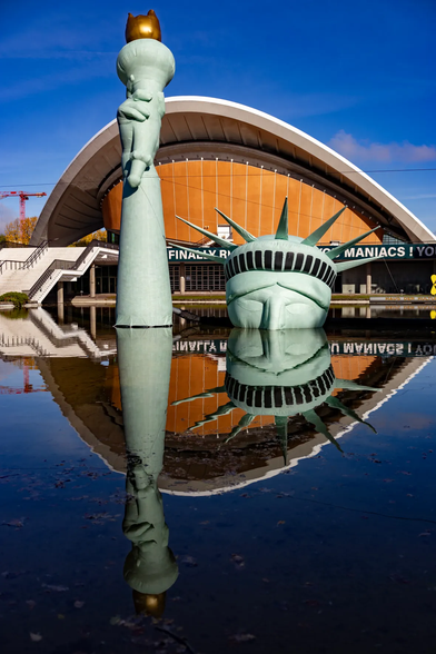 A partially submerged statue off Liberty