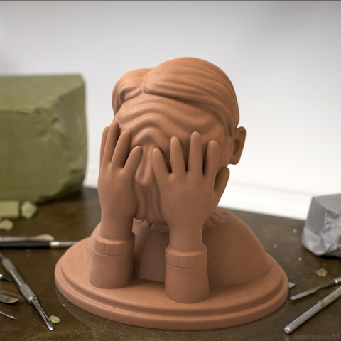Bust sculpture of a man holding his hands on his face, pushing thick wrinkles across the skin.