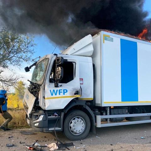 Damaged and burning WFP truck. Fire and a lot of black smoke on the roof. Photo posted on social media by the minister of Foreign Affairs of Ukraine