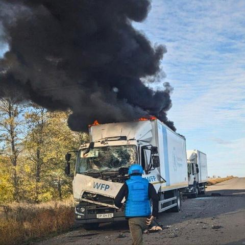 Damaged and burning WFP truck. Fire and a lot of black smoke on the roof. Another truck behind. Photo posted on social media by United Nations