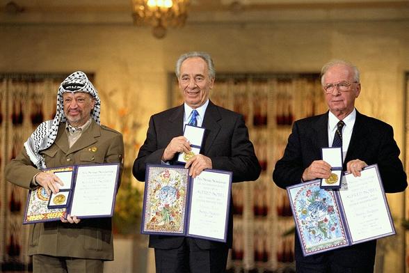 Arafat, Shimon Peres and Rabin receiving the Nobel Peace Prize following the Oslo Accords, 10 December 1994. By Government Press Office (Israel), CC BY-SA 3.0, https://commons.wikimedia.org/w/index.php?curid=22811903
