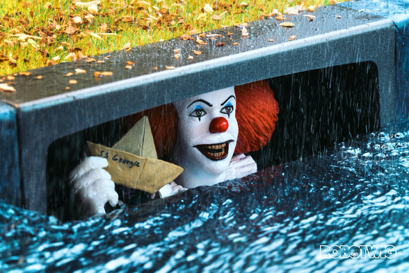 Pennywise appears from the sewer holding Georgies boat in his hand. Rain is pouring and water is going down into the sewer