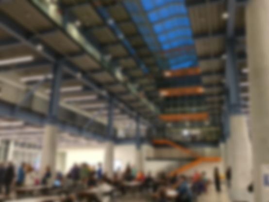 The large interior of the new St. Lawrence Market North Hall, set with tables, blurred for privacy.