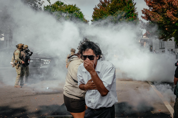 People fled after federal agents used tear gas on Tuesday along the Chicago street.