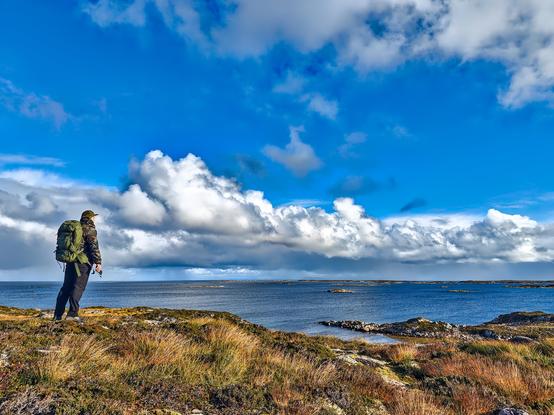 Me standing at the Norwegian coast near the European North Sea, looking towards the sea why the sky is covered with clouds
