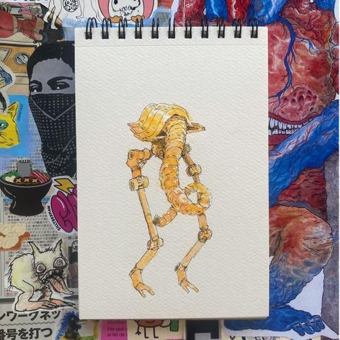 Ilustracion en acuarela en color amarillo de un robot con patas alargas y cabeza triangular aplanada, de la cabeza sale una trompa como de elefante que crece hacia abajo de manera retorcida. La ilustración está dibujada en un cuaderno de espiral con hojas blancas y ene l fondo hay un collage con fotos e ilustraciones variadas, se distingue en el collage una mujer guerrillera cubriendose la boca y la nariz con un paliacate