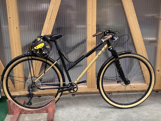 Black and gold step through bicycle with bee decals and brass stars