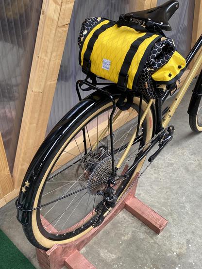 Black and gold step through bicycle with bee decals and brass stars