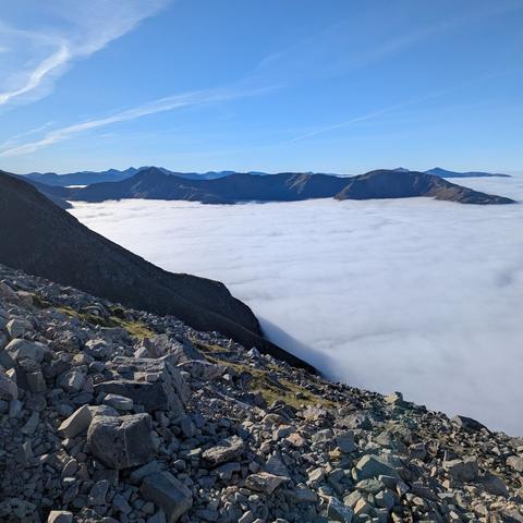 Mountains poking up through the clouds.