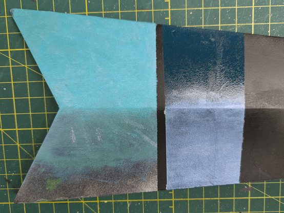 The other side of the blade with more patches of metalic teal and blue.