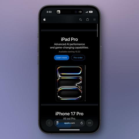 iPhone displaying Apple.com webpage showing the iPad Pro section. The page features a stylized black iPad Pro with glowing rainbow-colored edges forming an abstract shape against a black background. White text reads ‘iPad Pro’ with ‘Advanced AI performance and game-changing capabilities’ below, followed by ‘Available starting 10.22’ and blue ‘Learn more’ and outlined ‘Pre-order’ buttons. At the bottom, the beginning of an iPhone 17 Pro section is visible with the tagline ‘All out Pro.’