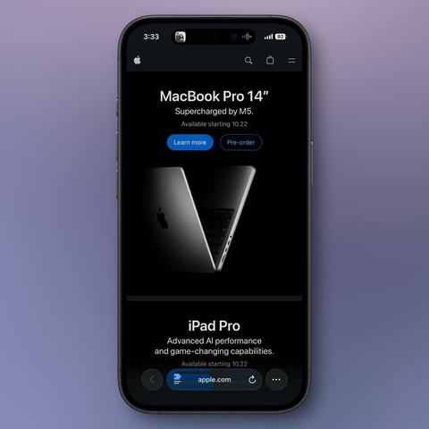 iPhone displaying Apple.com webpage showcasing the new MacBook Pro 14-inch with M5 chip. The page features a dramatic V-shaped composition of two MacBook Pros against a black background, with white text reading ‘Supercharged by M5’ and ‘Available starting 10.22’. Blue ‘Learn more’ and outlined ‘Pre-order’ buttons are visible below. The bottom portion shows the beginning of an iPad Pro section with text about ‘Advanced AI performance and game-changing capabilities.