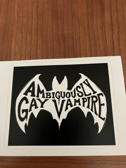 Sticker - black text on white bat “Ambiguously Gay Vampire”