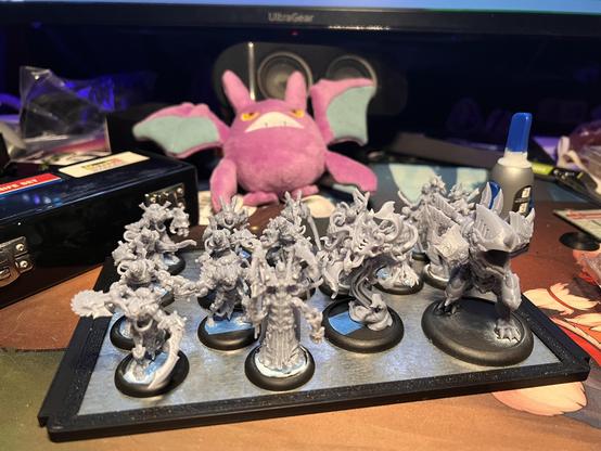 A tray of Cryx infantry models from Steamforged Games' Warmachine. The models in question are an assortment of steampunk zombies and surgeons, ready to add to the numbers of the undead. The light grey color of the models reveals that they have yet to be primed (let alone painted).
