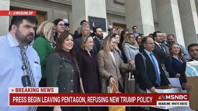 Presumably the entire Pentagon press core exiting em mass in protest of the Secretary of Defense new Press Pledge requirement that they use only Government sources in their reporting. A diverse group of professional men and women, all smiles as they exit via the steps.