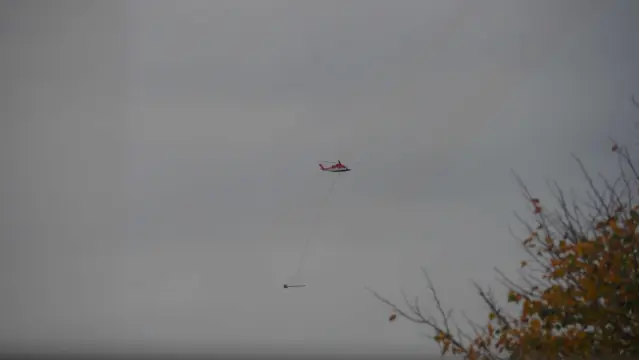 Hubschrauber mit Sonde  an langem Drahtseil