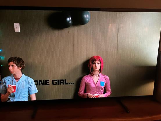 Photo of the movie ‘Scott Pilgrim Vs The World’. A boy and a girl are leaning against a wall at a party. The boy looks awkward.