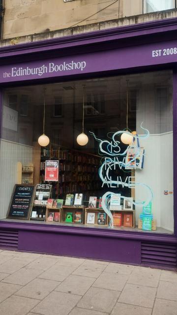 Longshot of the finished painted window design for Is A River Alive at the Edinburgh Bookshop