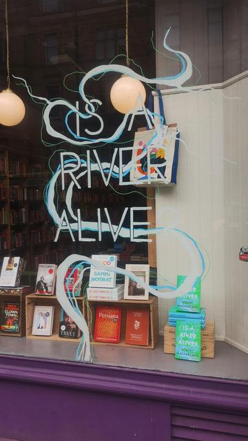 Close up of the finished painted window design for Is A River Alive at the Edinburgh Bookshop