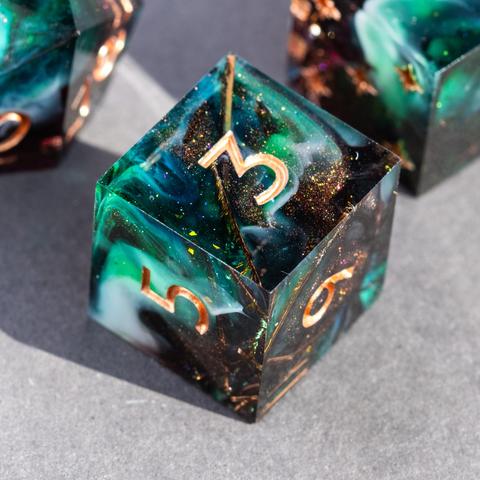 A D6 with peacock feathers and swirls of dark bronze glitter, green and white
