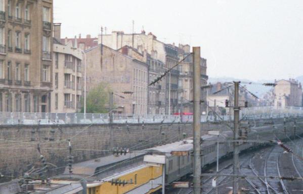 Au milieu d'immeubles, un pignon peint d'une publicité très effacée pour les petits-beurres LU.