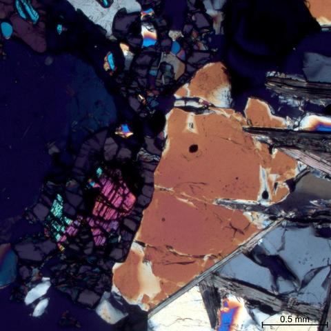 Yoderite surrounding remnant kyanite with talc and quartz. Cross polarized transmitted light.