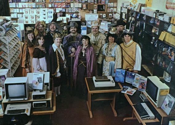 Photo of people in medieval costume standing in an Atari dealership called Computer Palace
