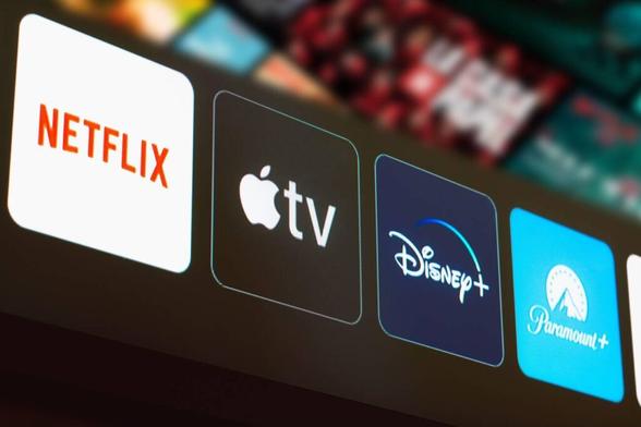 In this photo illustration the Netflix, Apple TV, Disney Plus and Paramount Plus logo is displayed on a TV screen.