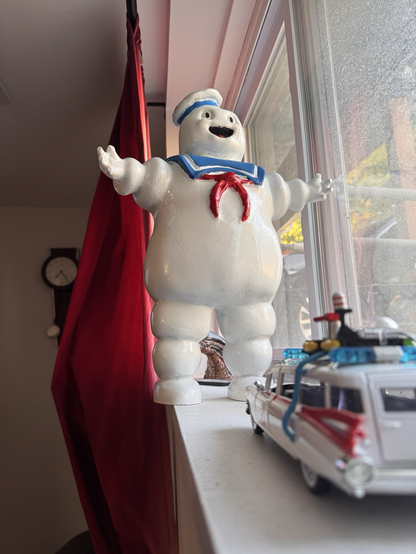 Stay Puft Marshmallow Man towers over Ecto-1
