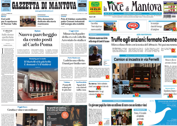 Schermata di un tablet o computer portatile che mostra le prime pagine di due quotidiani locali di Mantova: "Gazzetta di Mantova" e "la Voce di Mantova". Entrambi i giornali contengono vari articoli con titoli in evidenza, foto di cronaca e notizie locali, tra cui si leggono frasi come “Nuovo parcheggio da cento posti al Carlo Poma” e “Truffe agli anziani: fermata 33enne”. Sulla pagina della “Voce di Mantova” si vede anche la foto di un camion incastrato in una via.