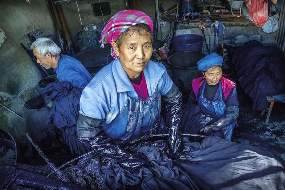 Bai people working on indigo-dyed batik textiles in their workshop (China).

There is a long history of batik production in China, dating back to the sixth century. Nowadays the tradition of batik is still practised by the minority groups who live mainly in Yunnan and other provinces in south western China.
All the minority people place great emphasis on their traditional dress which can help outsiders distinguish them from each other, and their costumes include Indigo-dyed batik elements. Hemp and cotton is dyed with a strong natural indigo to produce a very deep blue. Indigo dyeing is widespread throughout the area and there is great expertise in producing the indigo paste from the leaves, and dyeing the cloth. Girls traditionally start learning to produce batik from the age of 6 and 7 years.
However many of these textile skills are slowly dying out as printed imitations of batik synthetic dyes, and machine embroidered cloths have been introduced.

Website: <a href="https://robertopazziphoto.com/" rel="noreferrer nofollow">robertopazziphoto.com/</a>

Instagram: <a href="https://www.instagram.com/roberto_pazzi_photo" rel="noreferrer nofollow">www.instagram.com/roberto_pazzi_photo</a>