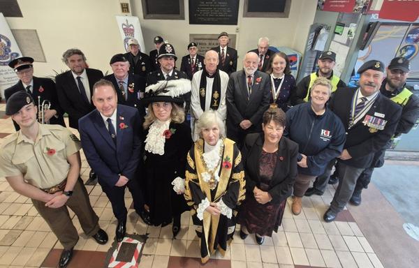 Group photo taken from above showing the Lord Mayor of Swansea in ceremonial robes surrounded by the High Sheriff, council leaders, armed forces representatives, veterans, councillors and police at the Poppy Appeal launch.