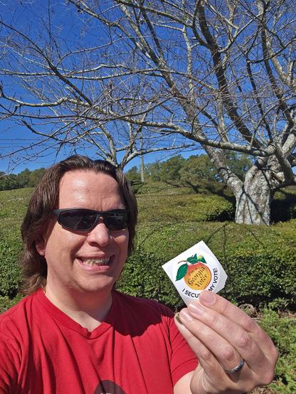 Me holding my I Voted sticker