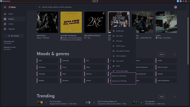 A screenshot of Zen Browser on the YouTube Music Explore page, with the right-click menu being visible, and two buttons at the bottom are highlighted with a magenta border: Add item to YTM Hide, Add artist to YTM Hide.