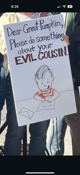 Poster drawing of Linus (from Peanuts) writing a letter to The Great Pumpkin. Linus writes, ‘Dear Great Pumpkin, Please do something about your EVIL COUSIN! ‘